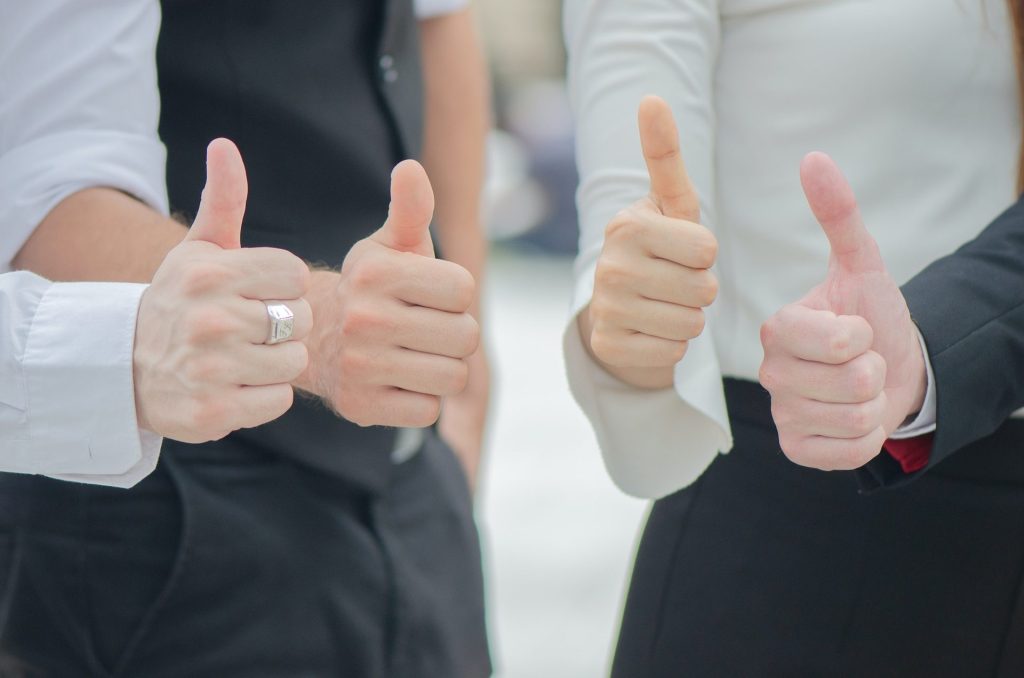 Business people thumbs up